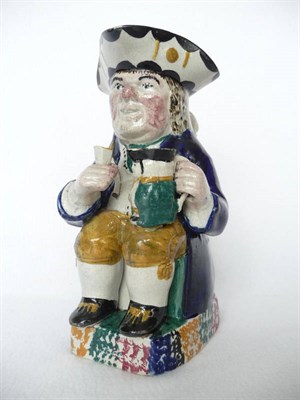 Lot 30 - A Yorkshire Pearlware Toby Jug, early 19th century, as a seated red faced drinker, holding a...