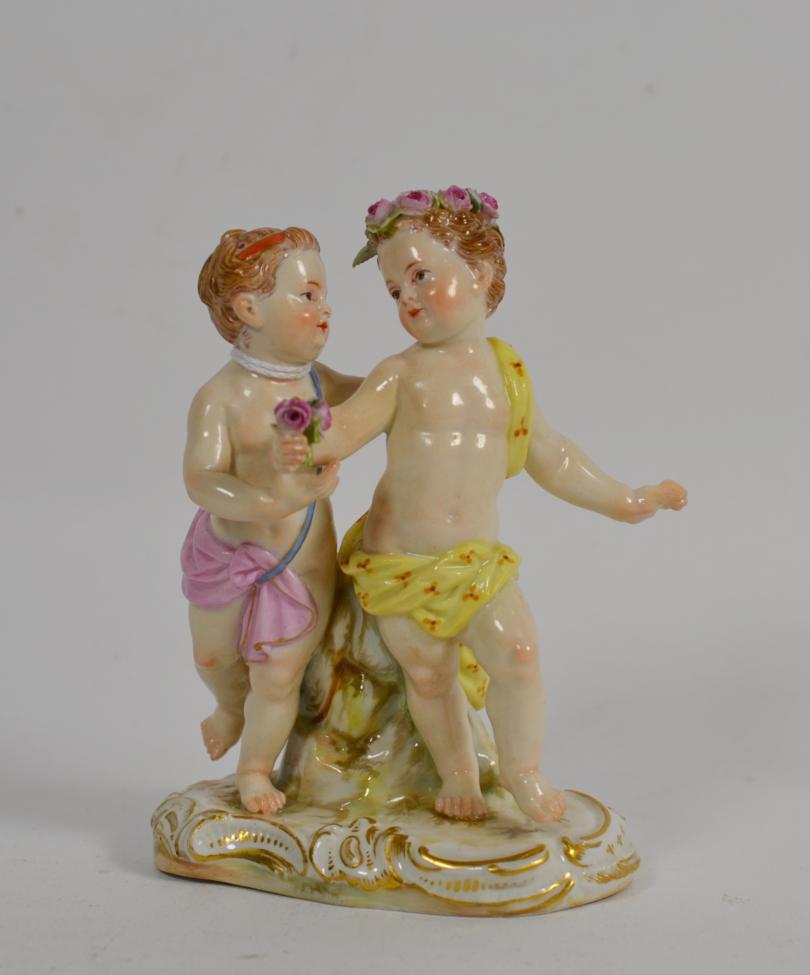 Lot 69 - A Meissen porcelain figure group, late 19th century, as a pair of children dancing, on a scroll...