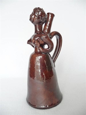 Lot 35 - A Treacle Glazed Earthenware Figural Flask, late 19th century, as a lady with long skirts, the...