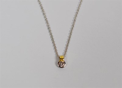 Lot 116 - An 18 carat, white and yellow gold solitaire diamond pendant, estimated diamond weight 0.15...