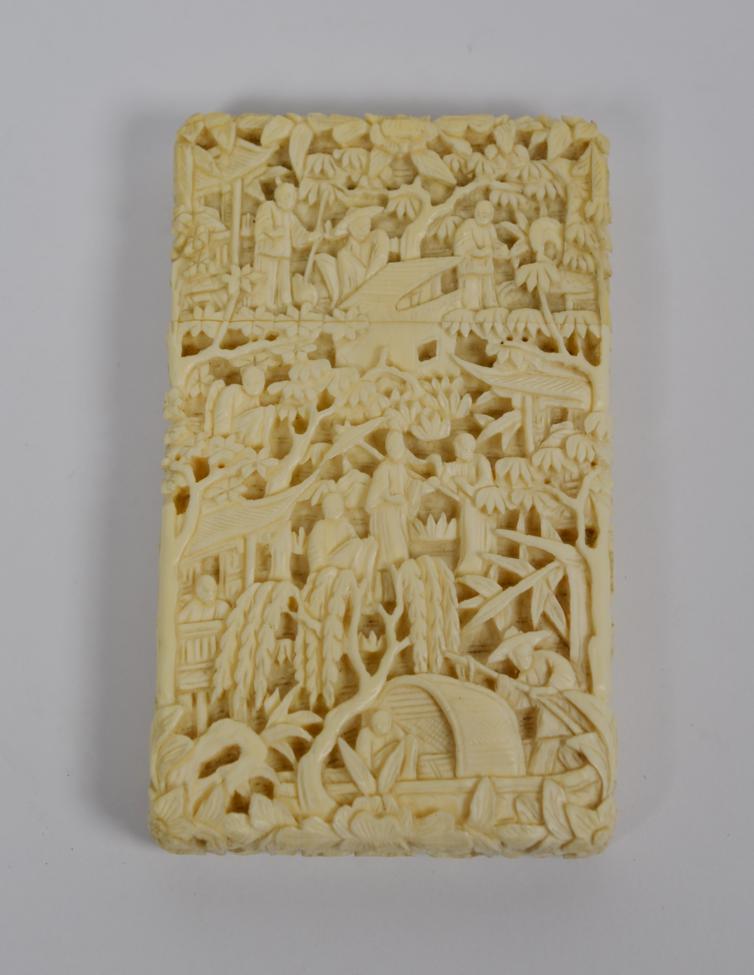 Lot 118 - A 19th century Canton carved ivory card case, intricately decorated with figures, in a landscape