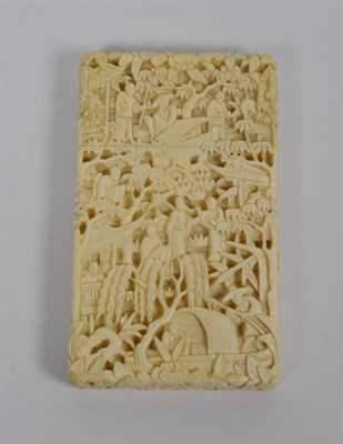 Lot 118 - A 19th century Canton carved ivory card case, intricately decorated with figures, in a landscape