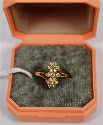 Lot 129 - A diamond triple cluster ring, stamped '14KP', finger size M