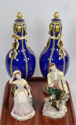 Lot 143 - A pair of 19th century gilt and cobalt blue ribbon tie twin handled decorative urns, together with