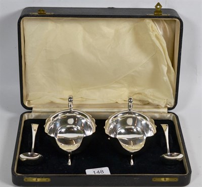 Lot 148 - A cased pair of George V silver sauceboats and ladles, by Viners, Sheffield, 1934, the...