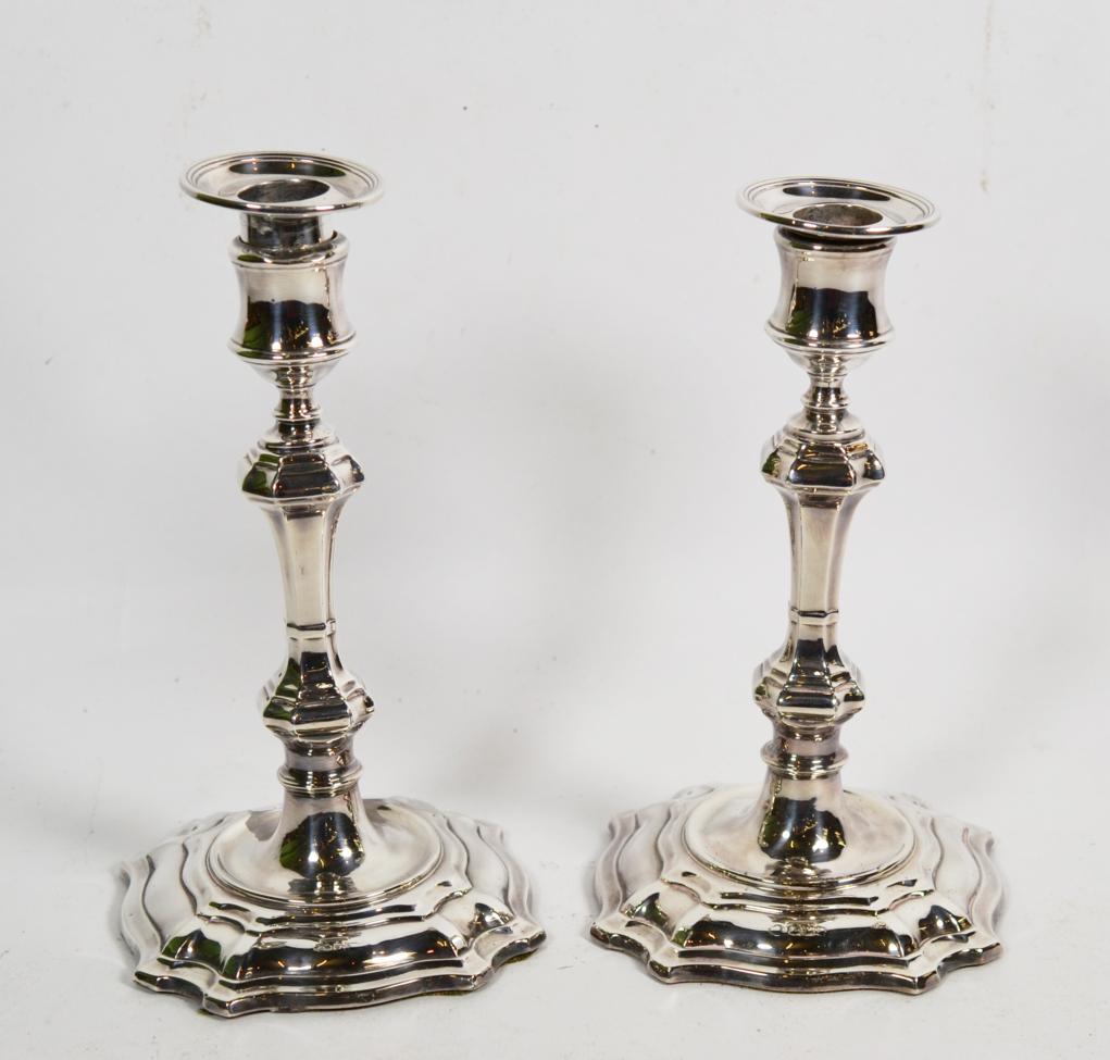 Lot 151 - A pair of George II style silver candlesticks, by William Hutton & sons