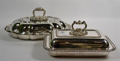 Lot 162 - Two silver-plated entree-dishes and covers, one shaped oval and with foliage border, the other...