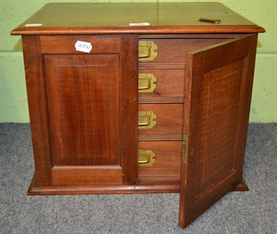 Lot 248 - A mahogany table top canteen, the two panelled cupboard doors, opening to reveal four fitted...