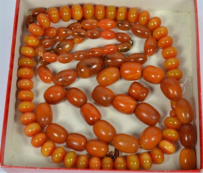 Lot 259 - Three amber type necklaces, lengths 51cm, 53cm and 64cm; together with an additional bead