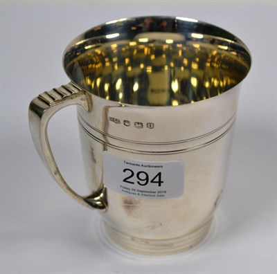 Lot 294 - An Elizabeth II silver mug, by Roberts and Belk, Sheffield, 1962, tapering and on reeded foot, with