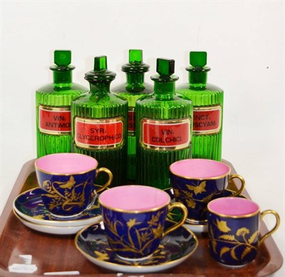 Lot 296 - Five green glass apothecary bottles, and some gilt highlighted tea wares with cobalt blue...