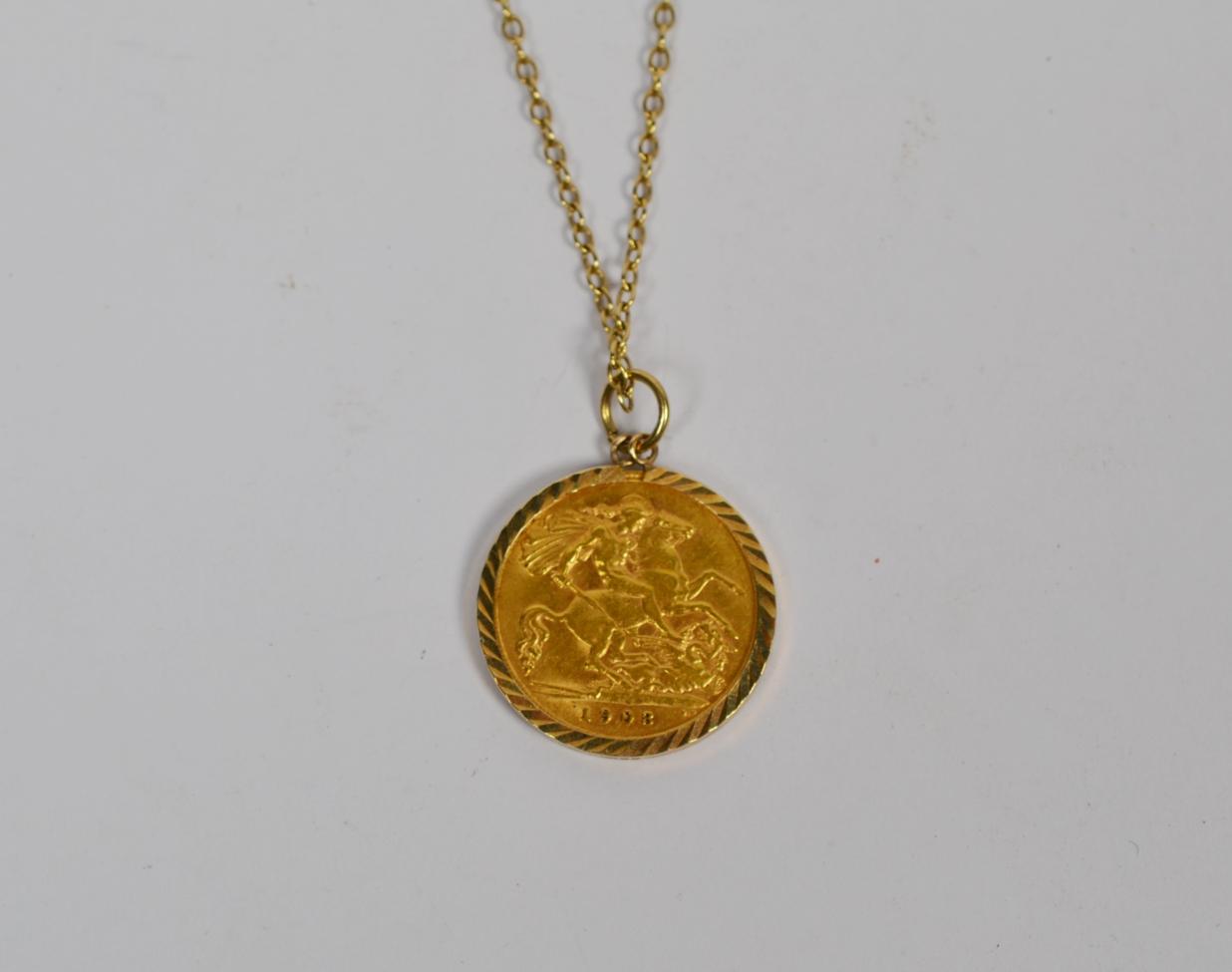 Lot 362 - A 1908 half sovereign in a 9 carat gold mount on chain, chain length 46cm