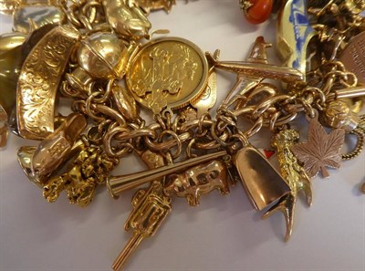 Lot 366 - A charm bracelet, hung with assorted charms, including an 1894 half sovereign, a shield back...