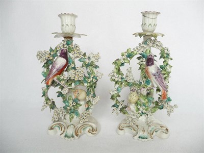 Lot 60 - A Pair of Derby Porcelain Chambersticks, circa 1770, each with fluted sconce and leaf shaped...
