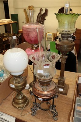 Lot 1008 - Four various Victorian oil lamps (all converted) together with a Victorian family bible (5)