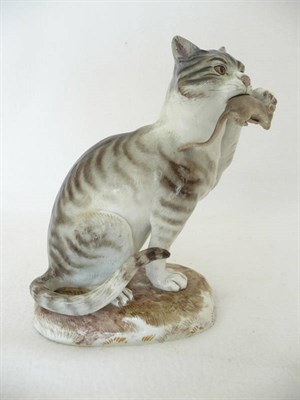 Lot 70 - A Meissen Porcelain Figure of a Cat, late 19th century, seated with a mouse in its mouth, on a...