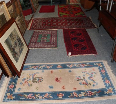 Lot 1145 - A Lahore Bokhara rug, the crimson field with two columns of quartered medallions, enclosed by...