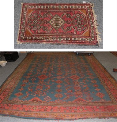 Lot 1147 - Ushak carpet, the blue/green field with columns of stepped guls and geometric motifs enclosed...