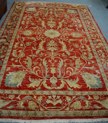 Lot 1149 - A Ziegler design carpet, blood red field of serrated vines around a flower head medallion, enclosed