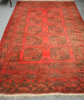 Lot 1150 - A Turkmen carpet, the burgundy field with two columns of elephant foot guls enclosed by...