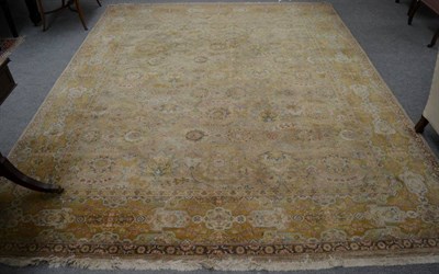 Lot 1155 - An Indian carpet, the abrashed field with columns of flower heads enclosed by mustard borders...