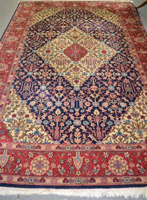 Lot 1156 - Tabriz carpet, the indigo diamond lattice field, with central ivory medallion, enclosed...