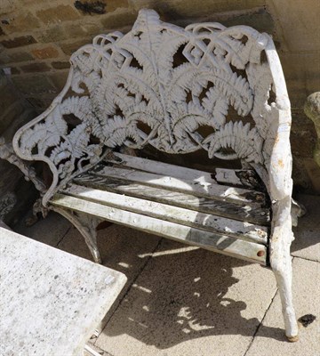 Lot 1170 - A late Victorian Coalbrookdale style fern decorated white painted cast iron bench