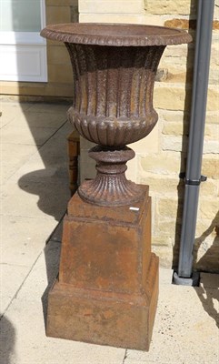 Lot 1172 - A cast iron part gadrooned urn on a stepped square plinth base