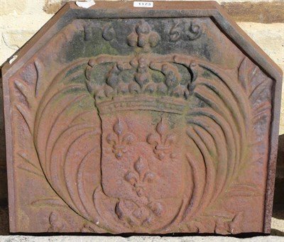 Lot 1173 - A cast iron fire back, shallow stone trough and a pair of red painted cast iron urns (4)