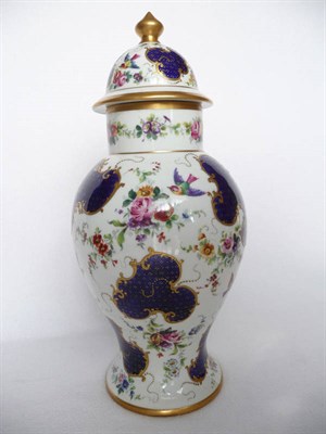 Lot 77 - A French Porcelain Baluster Vase and Cover, late 19th century, painted with birds amongst scattered