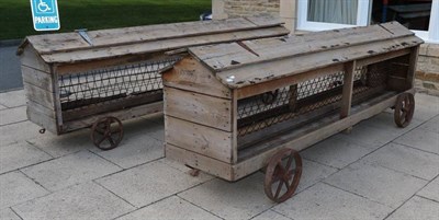 Lot 1184 - Two pine feeding racks mounted on cast iron wheels and with hinged covers