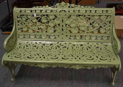 Lot 1185 - A reproduction green painted metal garden seat, 130cm wide