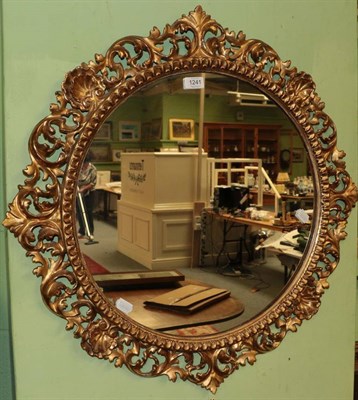 Lot 1241 - A 19th century carved giltwood circular mirror with an egg and dart border, 76cm diameter