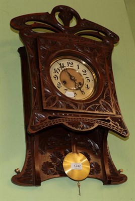 Lot 1242 - An Art Nouveau carved striking wall clock