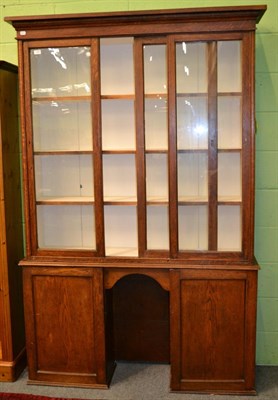 Lot 1257 - A early 20th century oak glazed display case, with two cupboard doors