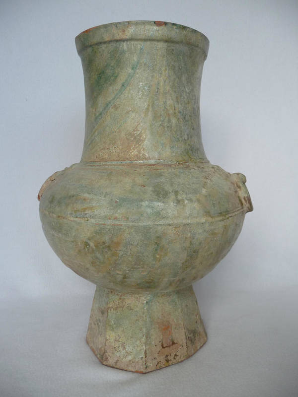 Lot 86 - A Chinese Terracotta Hu Vase, in archaic style with mask and ring handles, on a variegated...