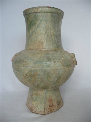 Lot 86 - A Chinese Terracotta Hu Vase, in archaic style with mask and ring handles, on a variegated...
