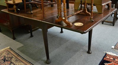 Lot 1271 - George II mahogany gateleg dining table, raised on tapering legs with pad feet