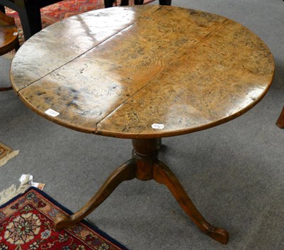 Lot 1291 - Burr ash circular tilt top table, on turned pedestal, and three cabriole legs