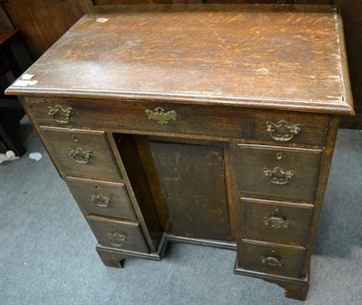 Lot 1325 - A George III oak kneehole dressing table, late 18th century, the moulded top above a long...