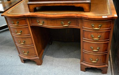 Lot 1336 - Reproduction yew wood serpentine shaped desk, 115cm wide