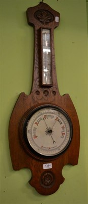 Lot 1384 - An early 20th century carved oak aneroid barometer