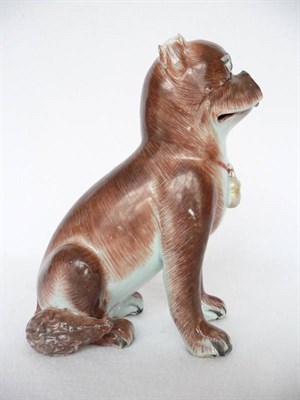 Lot 101 - A Chinese Porcelain Figure of a Seated Dog, 19th century, with brown markings, the amber collar...