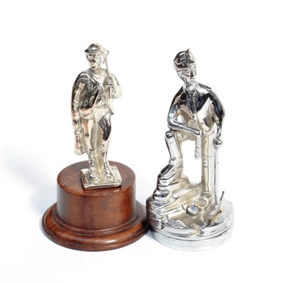 Lot 3029 - A Chrome on Brass Car Mascot, in the form of a miner carrying an axe and standing on a square base