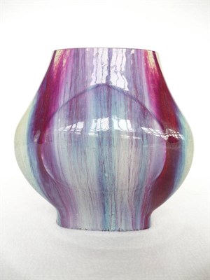 Lot 106 - A Chinese Sang du Boeuf Hu Form Vase, with moulded teardrop shaped panels on a streaky ground,...