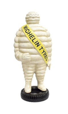Lot 3100 - A Cast Metal Advertising Figure of the Michelin Man, wearing a yellow sash and standing on a...
