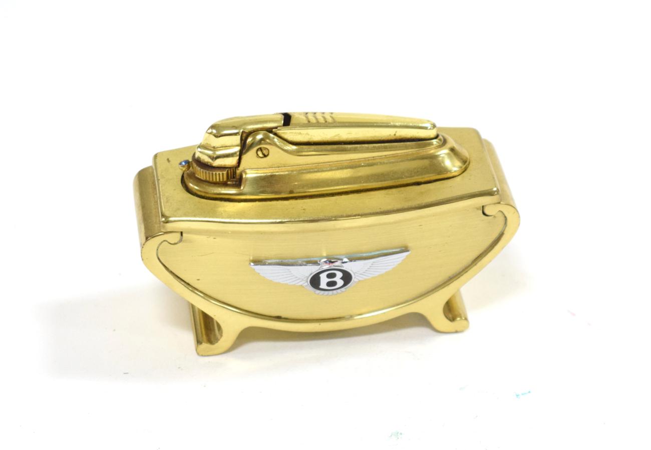 Lot 3105 - Bentley Interest: A 1950/60 Gilded Brass Car Showroom Desktop Ronson Lighter, the front with a...