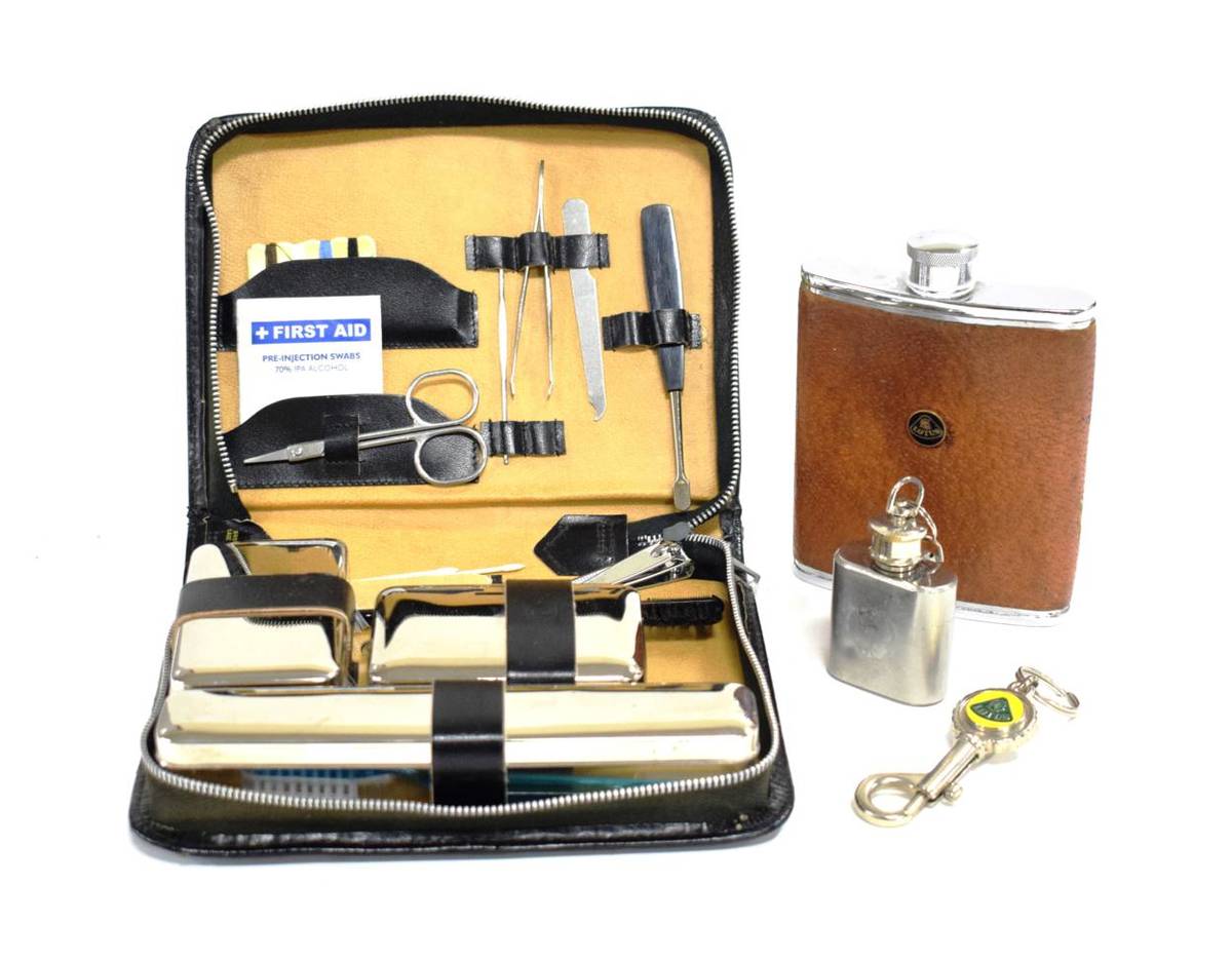 Lot 3111 - Lotus Interest: A 1960's Lotus Chrome Hip Flask; A 1960's Lotus Black Leather Travel Grooming...