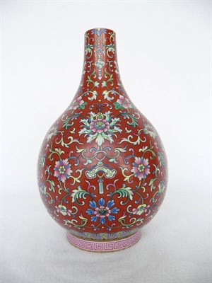 Lot 110 - A Chinese Porcelain Red Ground Bottle Vase, Daoguang mark, painted in famille rose enamels with...