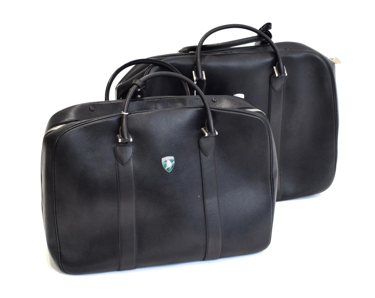 Lot 3129 - Lamborghini Interest: A Pair of Black Leather Travel Cases, with chromed fastenings and...